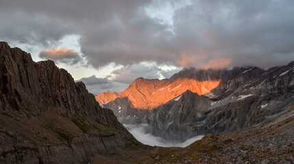 Wall Mural - Fiery sunset in the clouds over the Pyrenee mountains, France