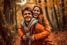 Happy Couple Piggybacking In A Forest One Autumn Afternoon