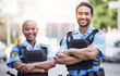© JessicaLeigh J/peopleimages.com - Happy, portrait and police with arms crossed in the city for security, safety and justice on the street. Team, pride and a black woman and a man with confidence working in urban crime together