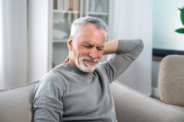 Senior man feels severe pain in his neck