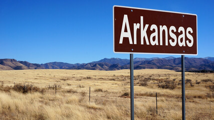 Arkansas road sign with blue sky and wilderness