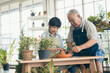 © ronnachaipark - Grandfather gardening and teaching grandson take care  plant indoors