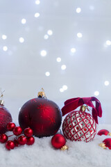 Poster - Christmas scene with snow - white and red balls with lights in background