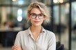 © pham - A short blonde hair businesswoman with glasses, standing confident and professional in the office, created with Generative Ai Technology