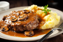 Delicious Home Cooked Salisbury Steak With Thick Luscious Brown Mushroom Gravy Served With Mashed Potatoes On A Plate. Traditional American Cuisine Dish Specialty For Family Dinner Holiday Celebration