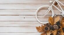  A White Bicycle With Pine Cones And Leaves On A Wooden Background.  Generative Ai