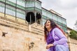 © Sangiao_Photography - Latin woman cheerful and happiness portrait in front of Casa Lis in Salamanca. Heritage tourism.