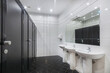 © alhim - Public bathroom in a modern office. The room is decorated in white and black.