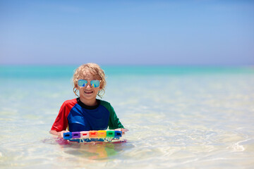 Wall Mural - Kids surf on tropical beach. Vacation with child.