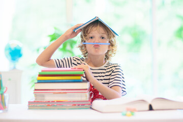 Wall Mural - Child with books doing homework after school.