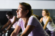 © JackF - Portrait of sporty woman training on stationary bike in gym