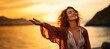 © Adriana - Backlit Portrait of calm happy smiling free woman with open arms and closed eyes enjoys a beautiful moment life on the seashore at sunset