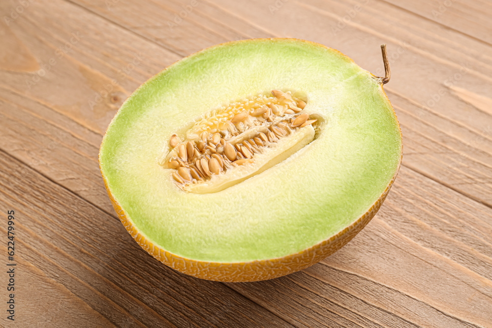 Half of sweet melon on wooden background