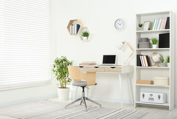 Wall Mural - Beautiful workplace with comfortable desk and chair at home