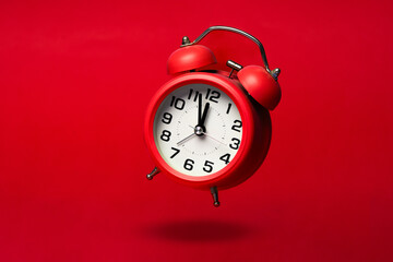 Red classic alarm  clock on the red background