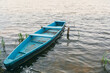 An old wooden boat on the shore of a lake in the countryside. Wooden boat for swimming on the lake