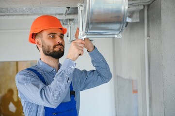 Wall Mural - hvac worker install ducted pipe system for ventilation and air conditioning. copy space