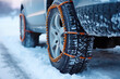 Car with chain attached to it's front tire in the snow. Generative AI.