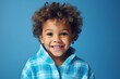 Portrait of a cute little african american boy in bathrobe on blue background