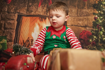 Wall Mural - happy little boy playing with toys at christmas