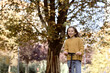 © gpointstudio - Caucasian child having fun in the woods while driving a push scooter
