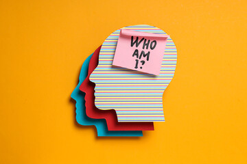 Colorful paper heads and note with text on yellow background