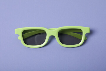 Green glasses with tinted lenses on purple background