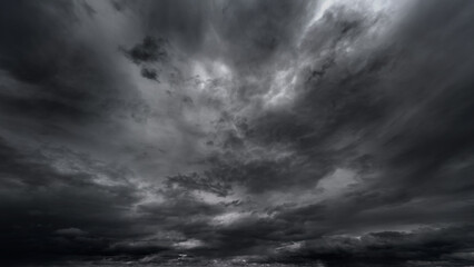 Wall Mural - dark dramatic sky with black stormy clouds before rain or snow as abstract background, extreme weath