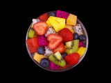 Fototapeta  - Top view of bowl with fruit salad isolated on black background