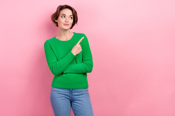 Sticker - Photo of charming young marketer woman promoter wear green jumper look interested advert presentation isolated on pink color background