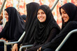 © the_lightwriter - A group of young muslim women wearing headscarves having fun together at the fair