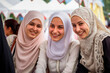 © the_lightwriter - A group of young muslim women wearing headscarves having fun together at the fair