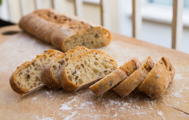 Wall Mural - fresh loaf of bread on wooden board