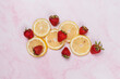 strawberries and lemons on pink marble background