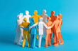 © ink drop - Paper cut out people standing together holding hands. Business teamwork and collaboration