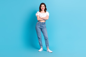 Wall Mural - Full length photo of charming confident girl dressed white top smiling arms crossed isolated blue color background