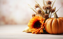 Autumn Pumpkin With Sunflower Dry Leaves And Flowers On Blurred Bokeh Lights White Background With Copy Space. Wooden Floor. Halloween Concept. Happy Thanksgiving. Greeting Card Concept