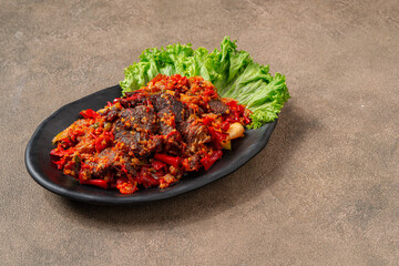 Wall Mural - Jerado balado or Dendeng balado is a traditional cuisine from west sumatera, indonesia. it is made from slice of beef with spicy sauce called sambal.