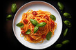 © chandlervid85 - spaghetti with tomato sauce on white plate on black background. Top view