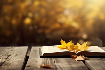 Poster - Autumn background. A book and yellow maple leaves.