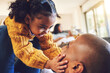 © Azee/peopleimages.com - Happy father, girl and touch face in home living room, bonding and having fun together. Smile, dad and child play with cheeks, family and kid with care, love and enjoy quality time to relax in house.