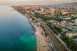 The aerial drone picture of Caspian sea beach in the city of Mahachkala, Dagestan, southern Russia with residential areas during the sunset