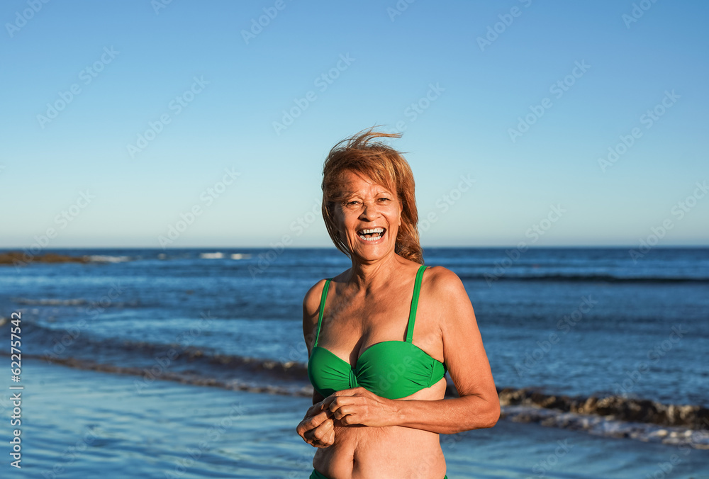 Happy senior latin woman smiling on camera during summer vacation on ...