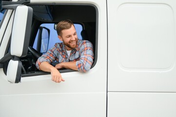 Canvas Print - Close up of truck driver behind steering wheel. Copy space.