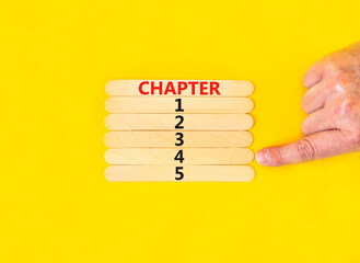 Wall Mural - Time to chapter 4 symbol. Concept word Chapter 1 2 3 4 5 on wooden sticks. Businessman hand. Beautiful yellow table yellow background. Business planning and time to chapter 4 concept. Copy space.