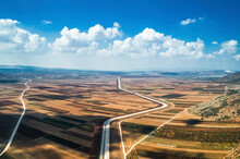 Aerial View Of A Road Crossing The Countryside With Agricultural Fields In Northern District Of Israel.