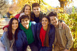 © Studio Romantic - Positive young friends posing for photo in park. Group of young people standing together and smiling at camera. Guys and girls walking and having good time in autumn sunny day