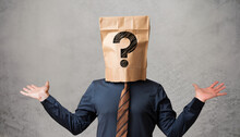 Businessman Wearing Paper Bag On Head With A Question Mark Concept