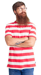 Wall Mural - Handsome young red head man with long beard wearing casual clothes smiling looking to the side and staring away thinking.