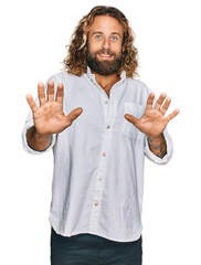 Wall Mural - Handsome man with beard and long hair wearing casual clothes afraid and terrified with fear expression stop gesture with hands, shouting in shock. panic concept.